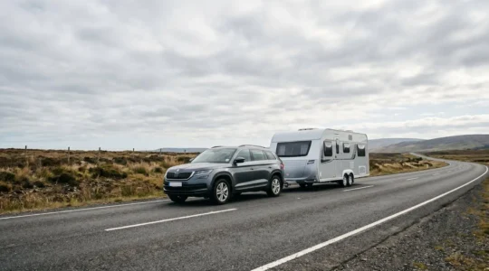 Wide angle view of a caravan being towed on a highway, demonstrating stable towing technique with proper weight distribution and balanced setup