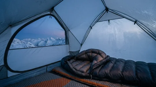 Close-up of a down sleeping bag lofted inside a tent during freezing outdoor conditions