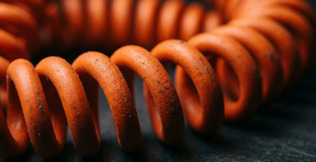 Extreme close-up of orange electrical cable coils showing textural detail and material quality