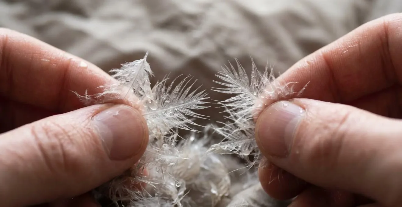 Hands gently breaking apart clumps of down insulation in a wet sleeping bag