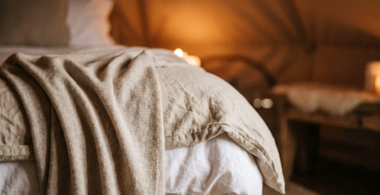 Soft romantic detail of luxury glamping tent interior prepared for intimate proposal moment with natural candlelight and premium textures