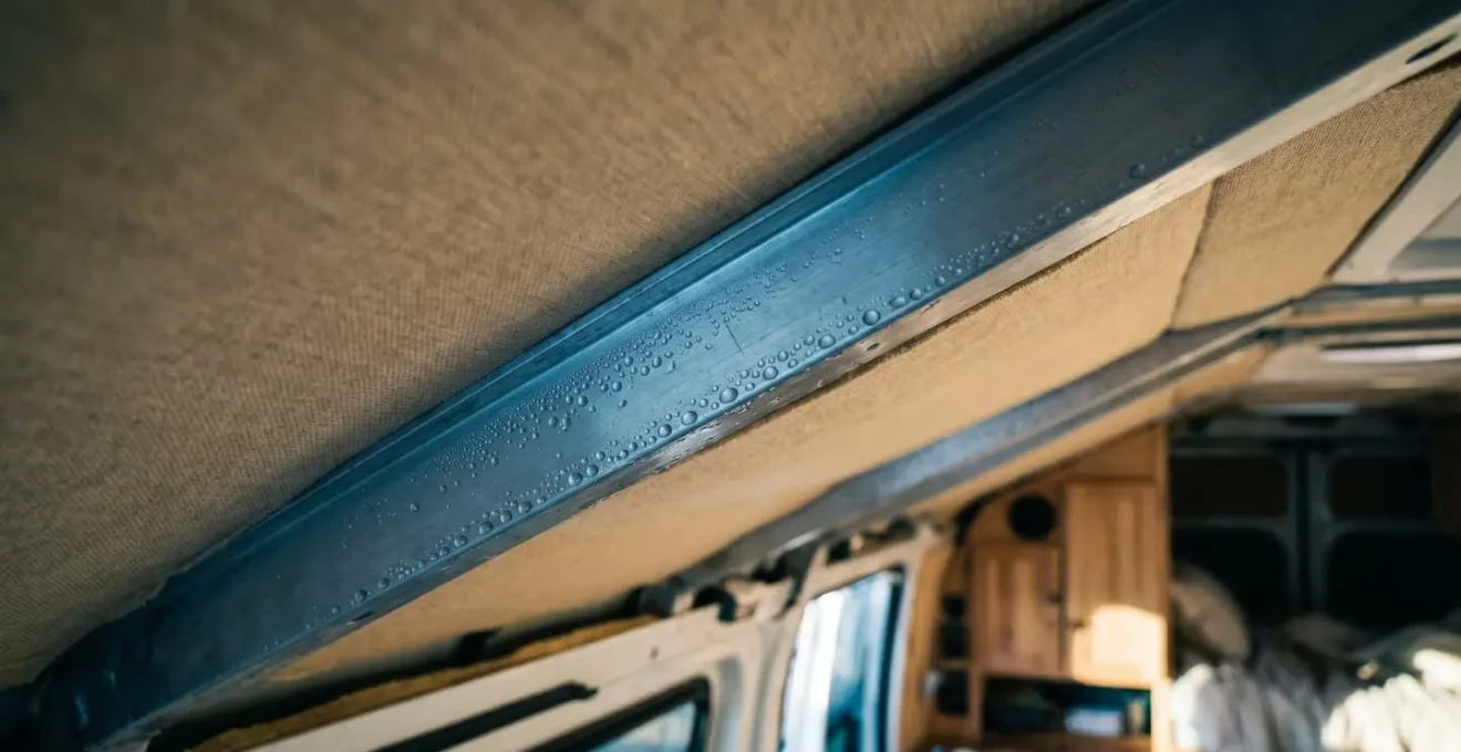 Close-up of van metal ceiling rib showing temperature differential and condensation formation