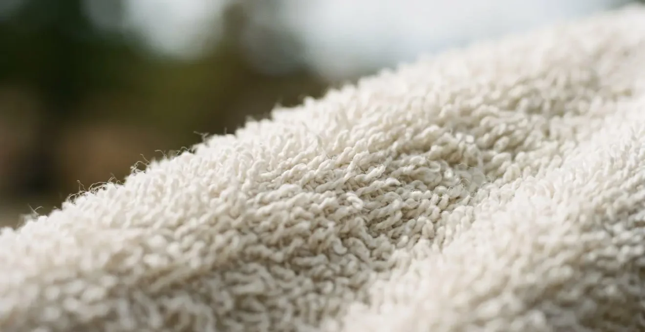 Close-up macro view of towel fibers showing texture and weave pattern with natural lighting emphasizing the fabric structure