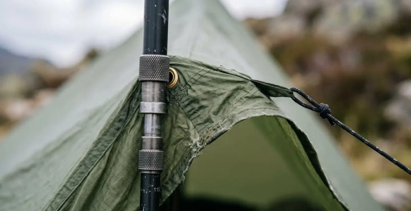 Close-up detail of trekking pole adjustment creating pressure differential and airflow in single-wall tent setup