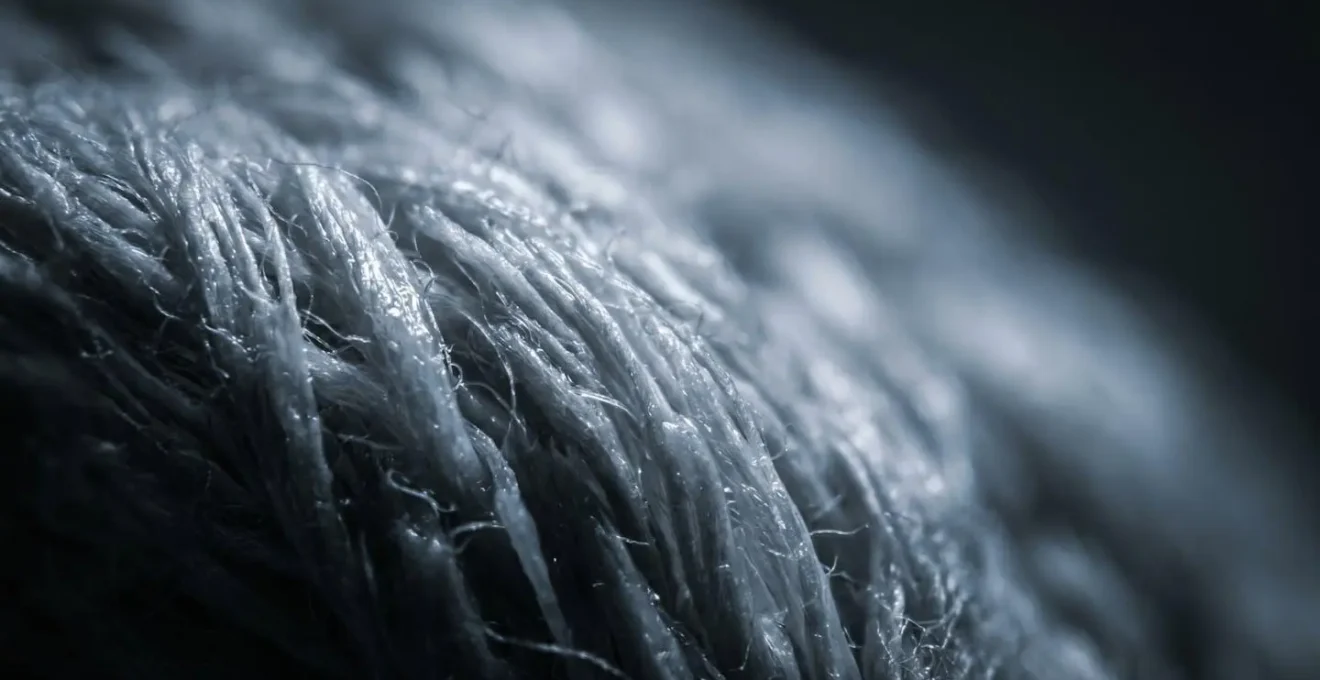 Extreme macro photograph showing saturated cotton fibers losing structure and compression texture details